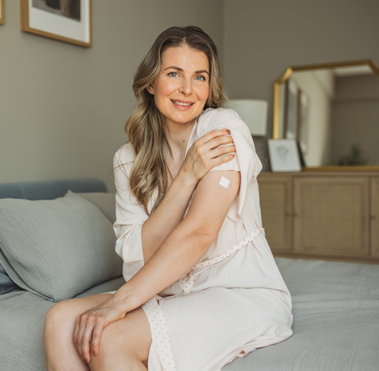 a woman sitting on a bed