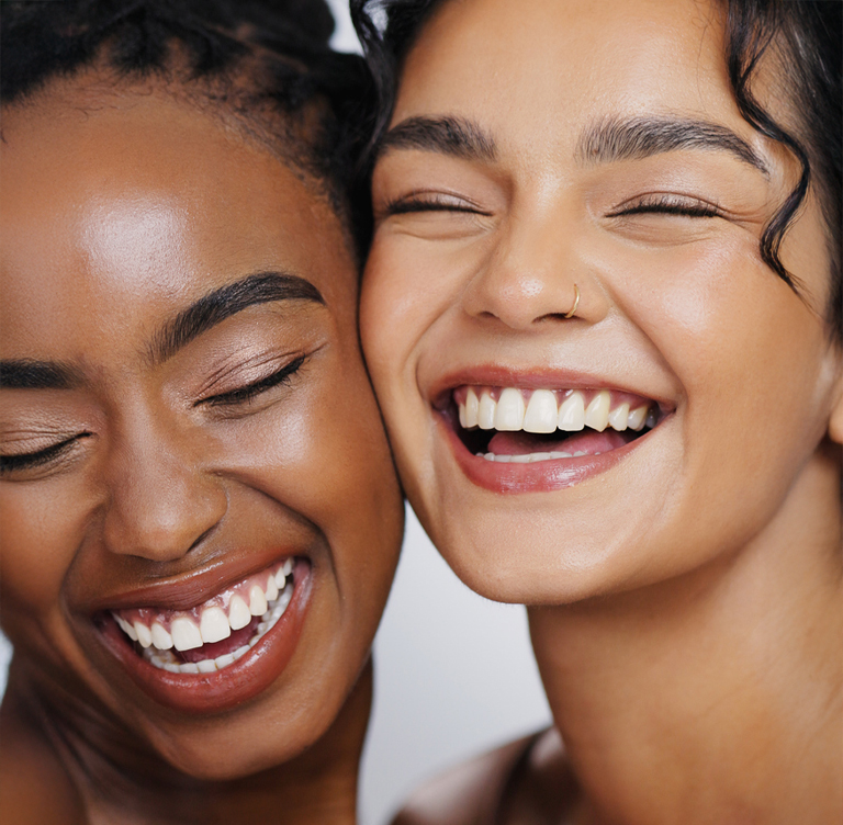 a close up of a woman who is smiling and looking at the camera