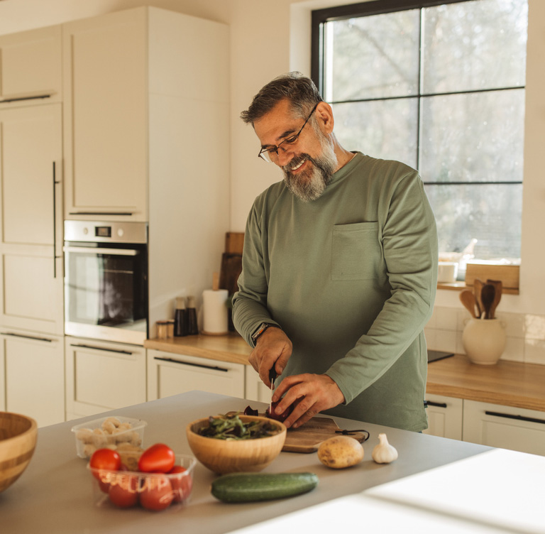 a man standing in a kitchen preparing food