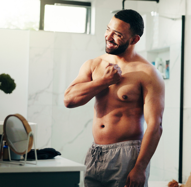 a man standing in front of a mirror posing for the camera
