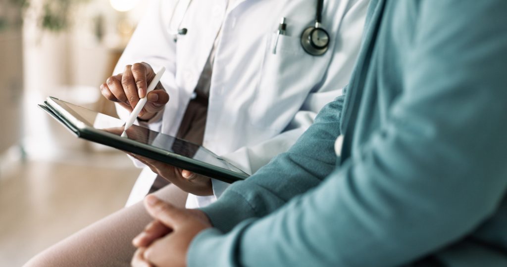 Man reviewing health information with a provider at a men's wellness clinic in Tuscaloosa, Alabama.