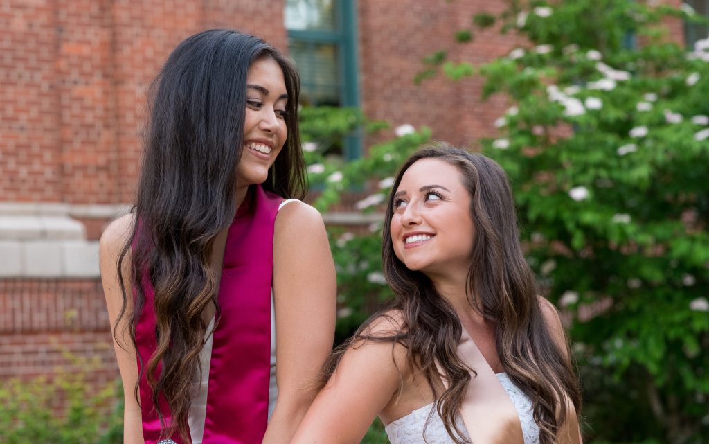 Two girls in a sorority pose together in a photo after booking skincare treatments.